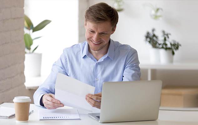 Smiling paralegal viewing his printed payslip