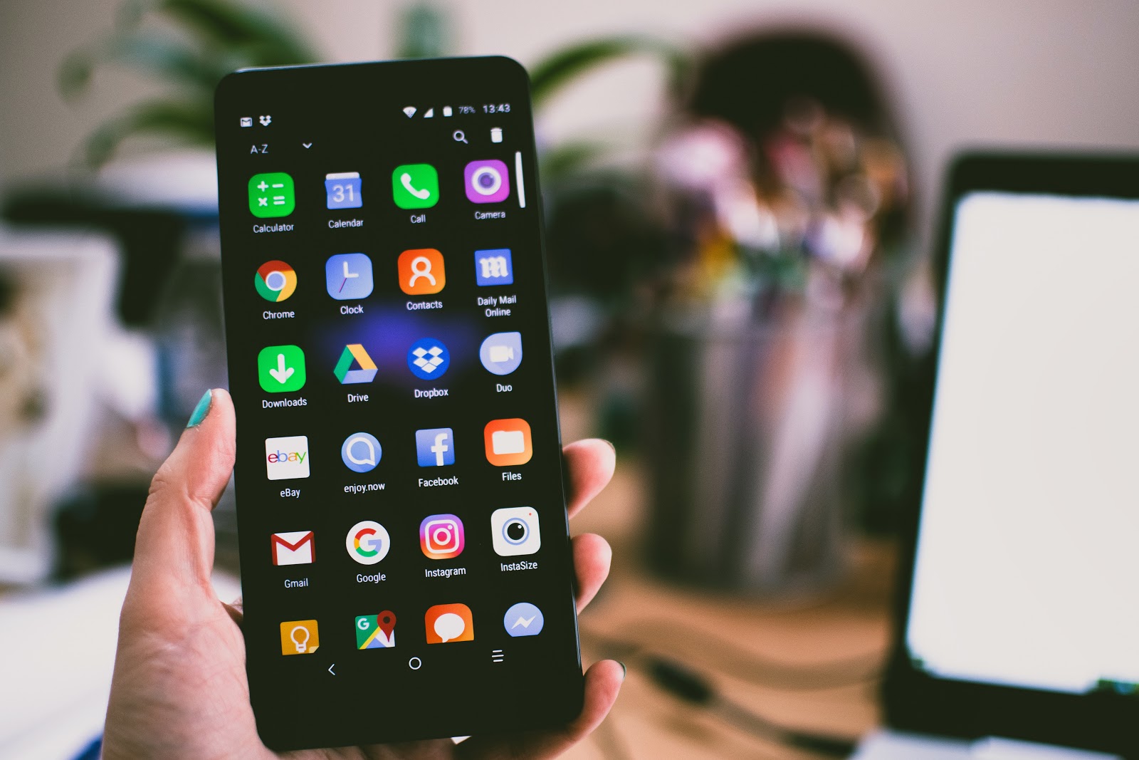 Person showing off all mobile apps on smartphone.