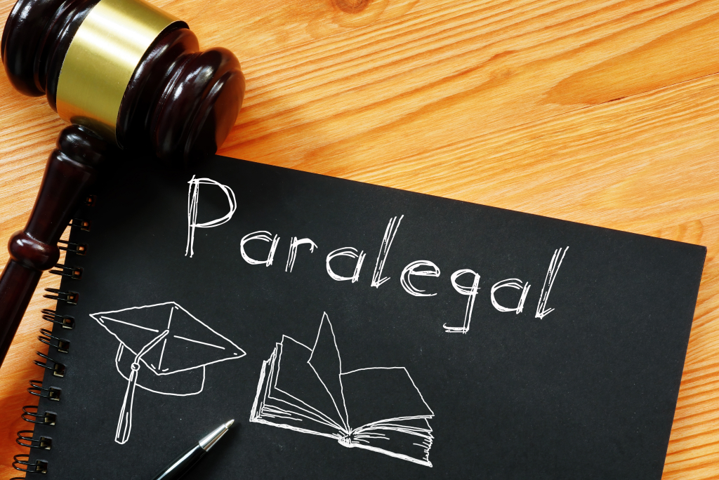  A book with the word paralegal on it and a gavel next to it.