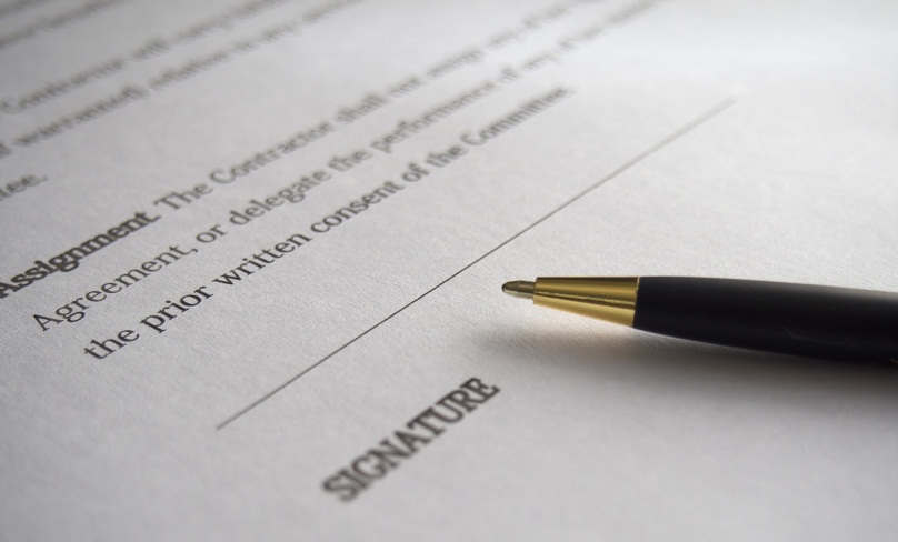 Close up of a contract and a pen.