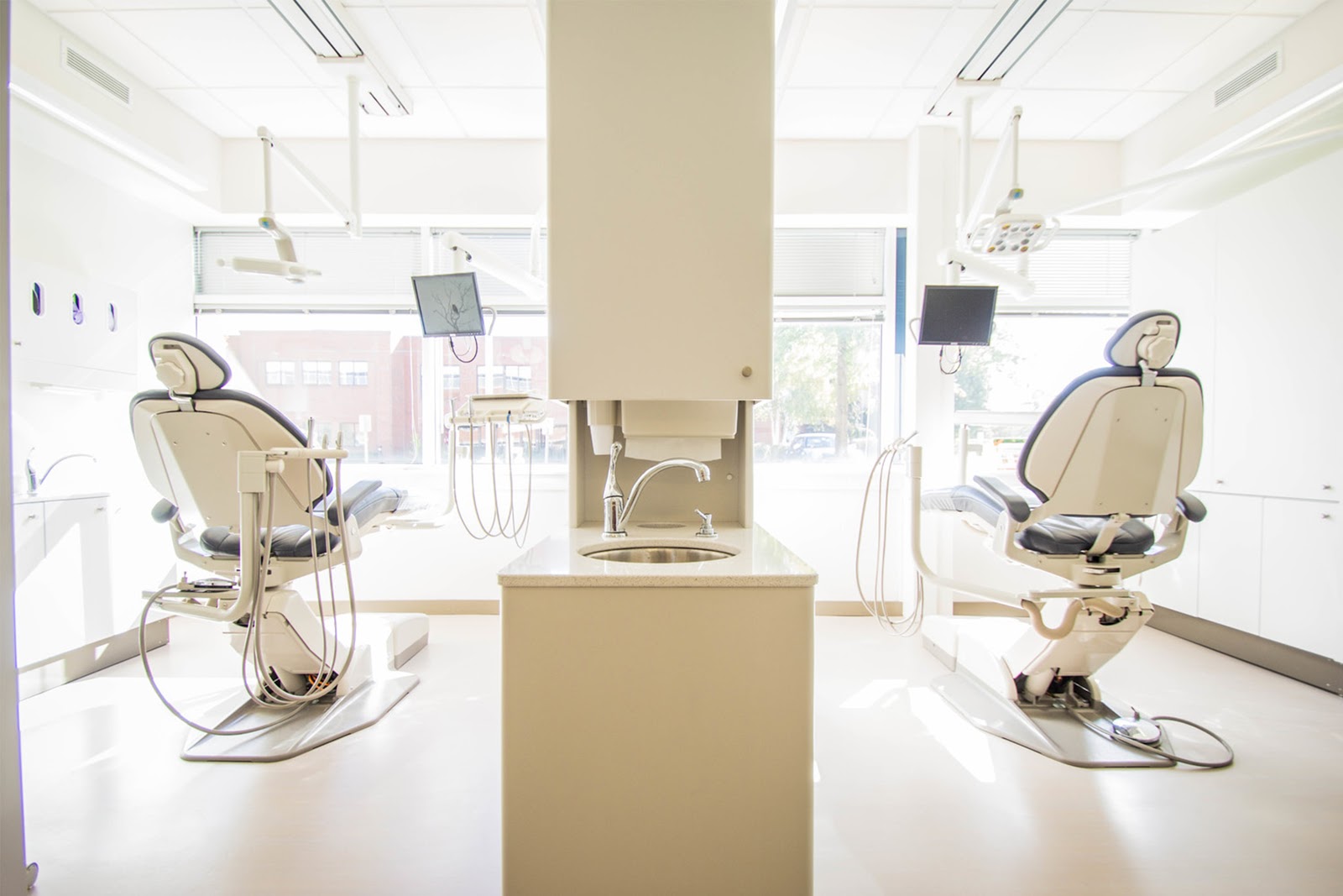 A sparkling clean dentist’s office with two chairs visible to showcase the different career paths you can take with a dental assisting program