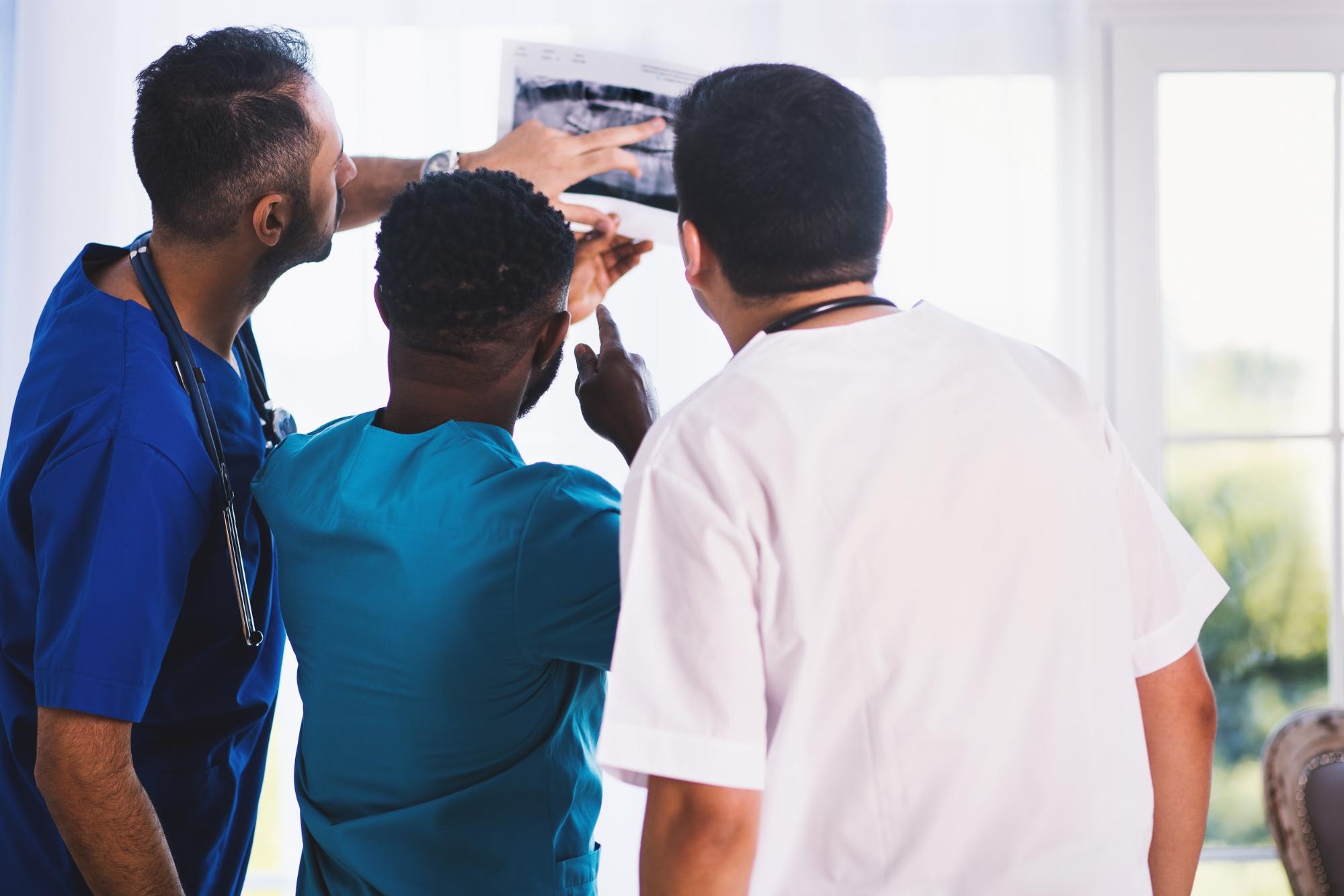 Dental assistants looking at x-rays