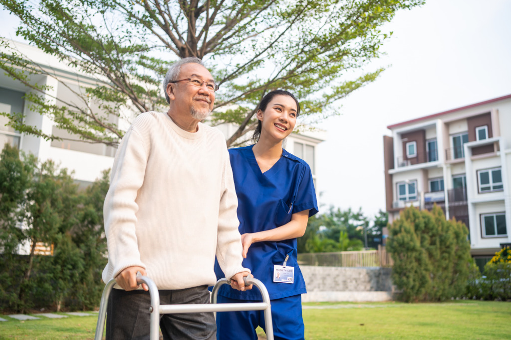A person with nurse walking with a walker