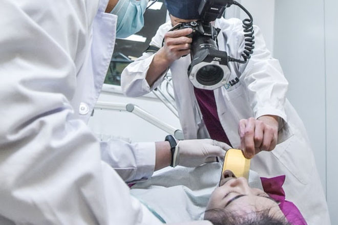 Dentist and dental assistant taking an x-ray