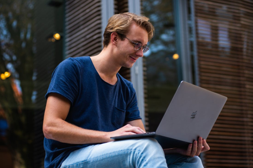 Man taking online classes from his laptop