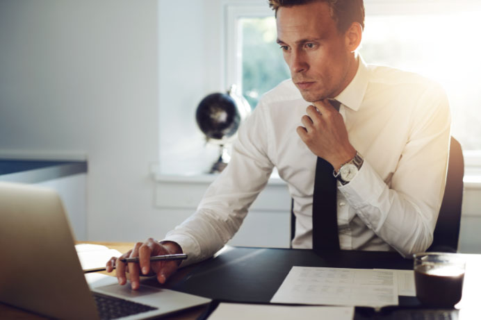 Paralegal doing legal research at his desk