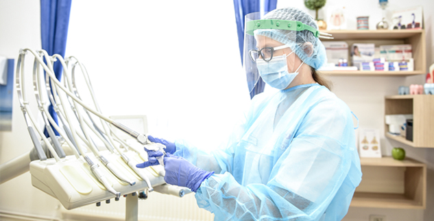 A dental assistant smiling while holding a clipboard