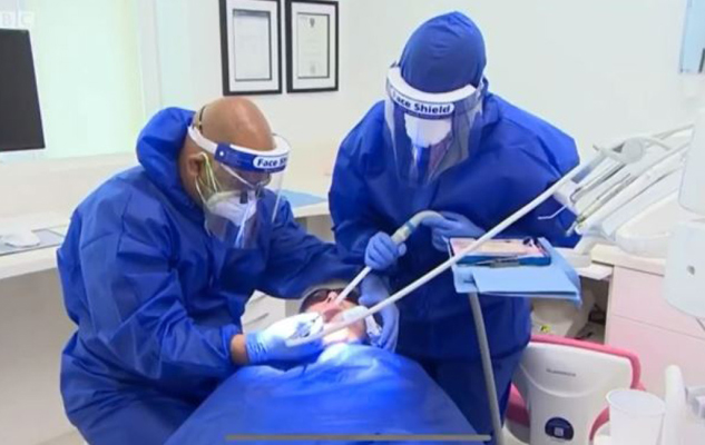 Level II dental assistant working closely with a dentist