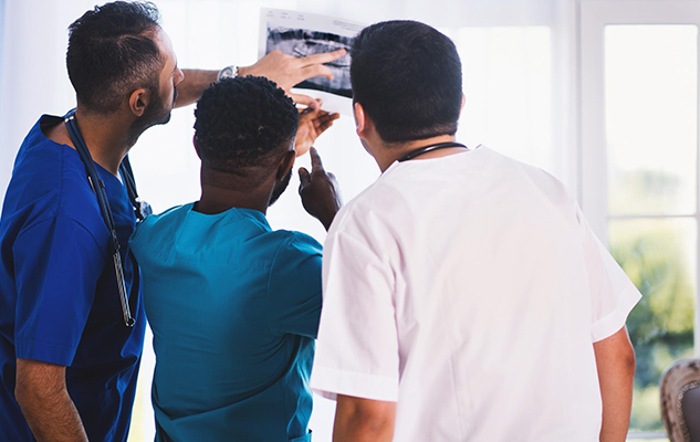 Dental assistants looking at x-rays