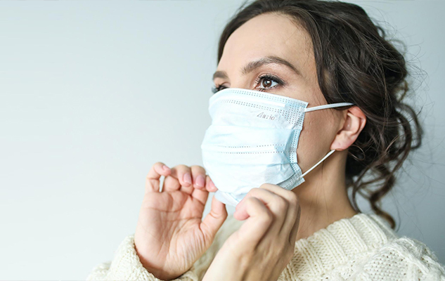 Personal support worker in home-care putting on a mask