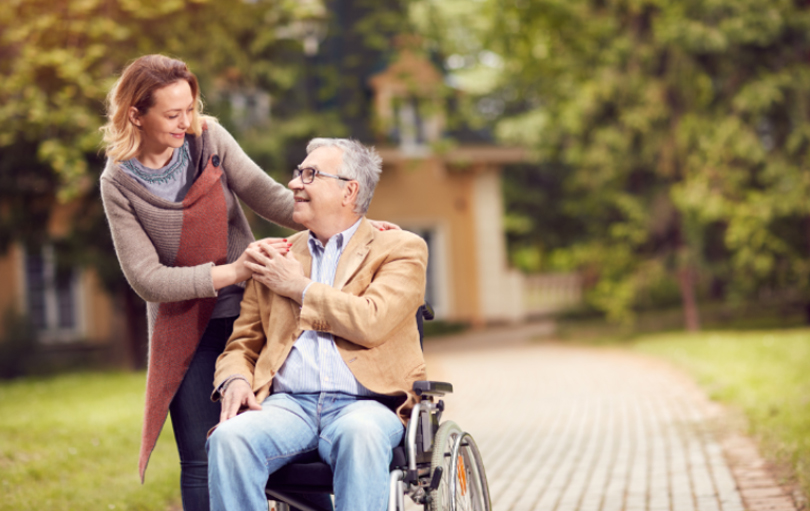 Personal support worker pushing a disabled client’s wheelchair