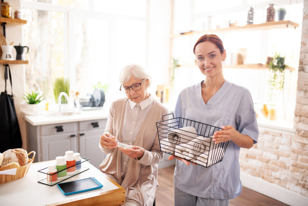 A person and a nurse holding a basket of towels