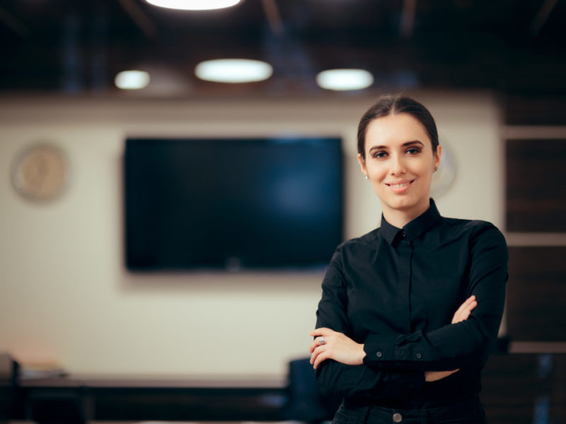 Receptionist,Woman,In,Front,Of,Her,Desk,Greeting,Customers.,Portrait